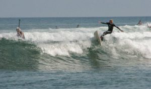 surfer riding waves in malibu