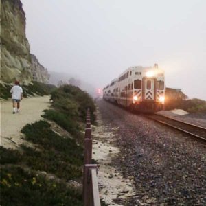 train with lights coming out of fog